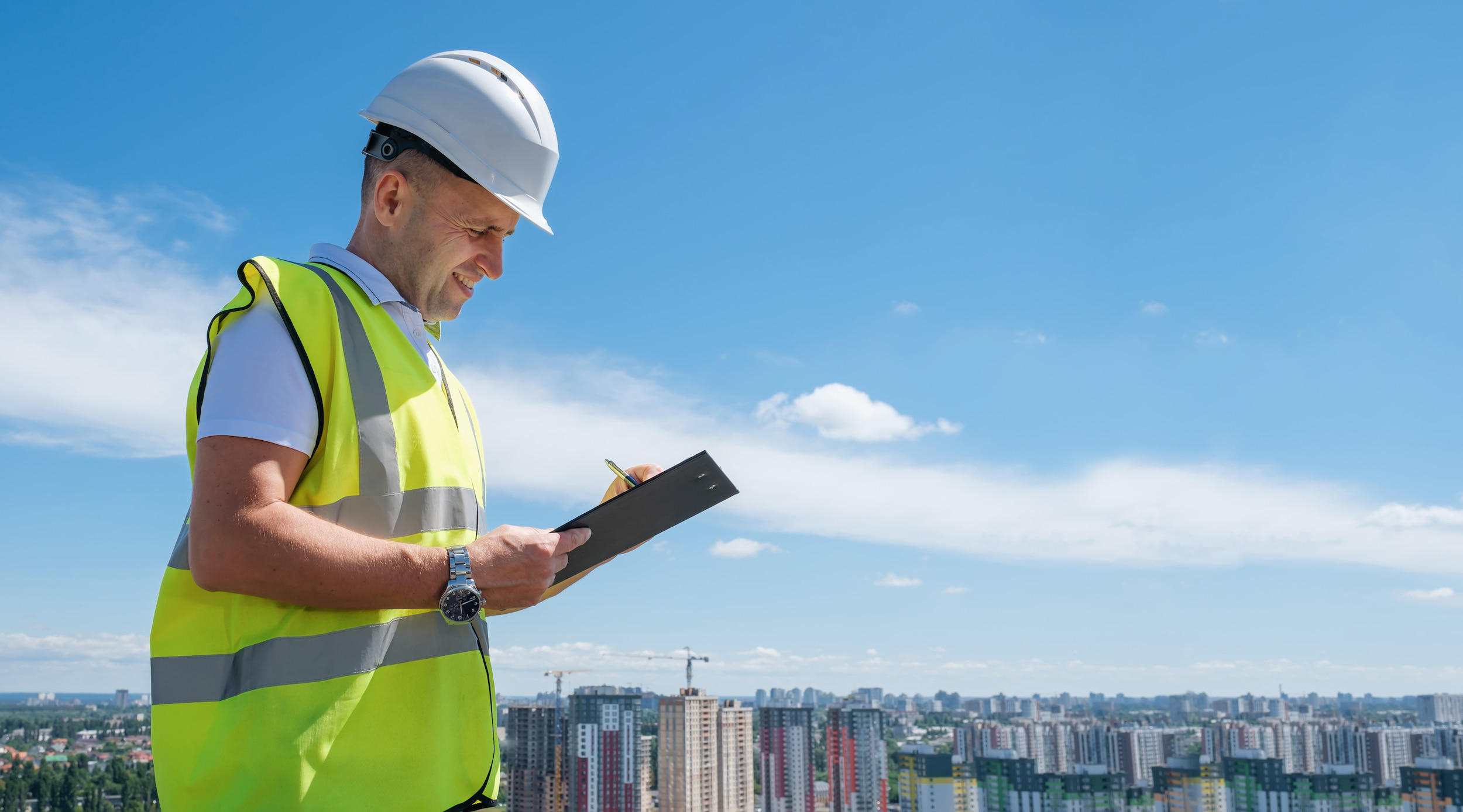 A man in white hat completing a roof survey.